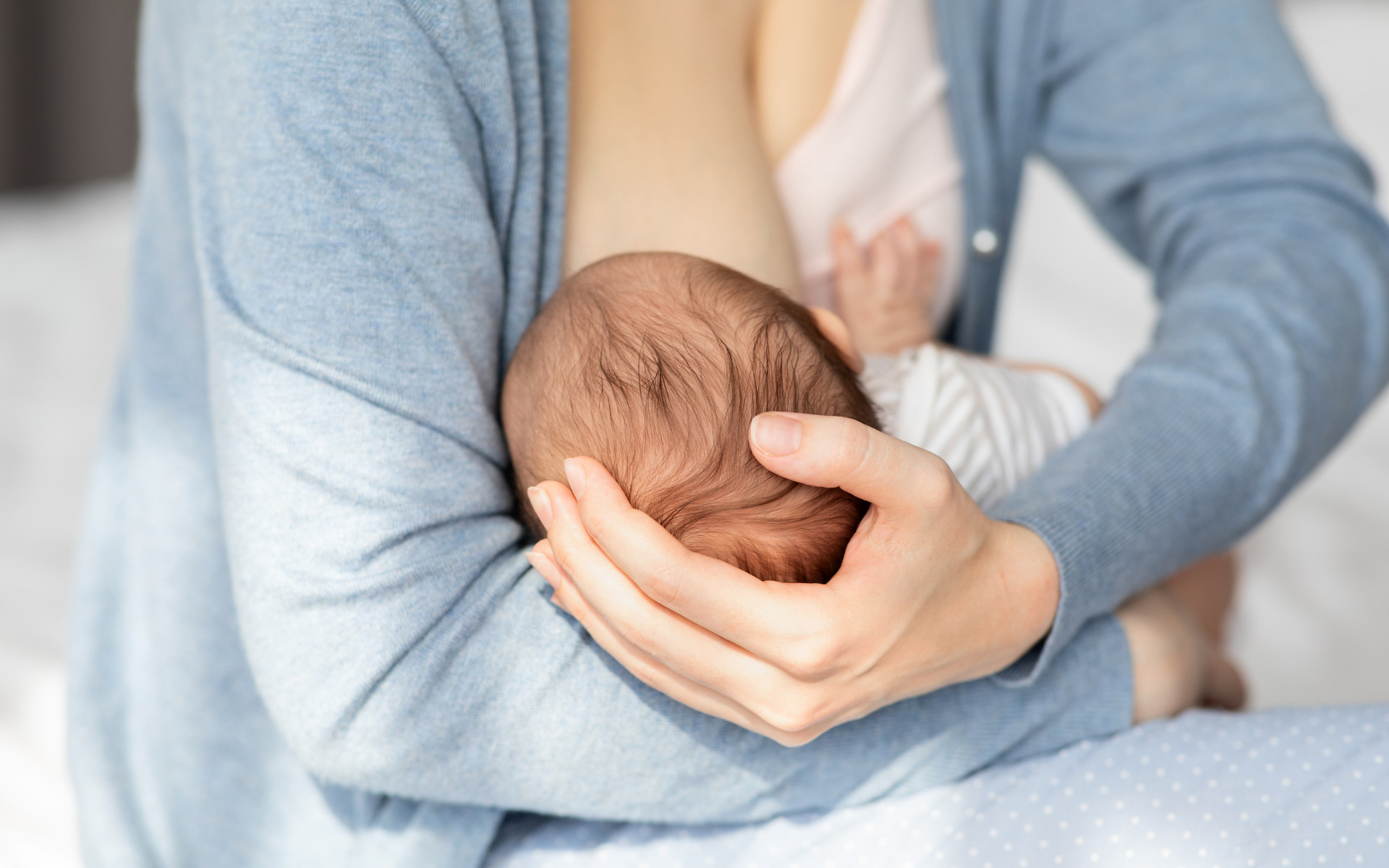 A mother breastfeeding her baby in their Burtonsville, MD home.