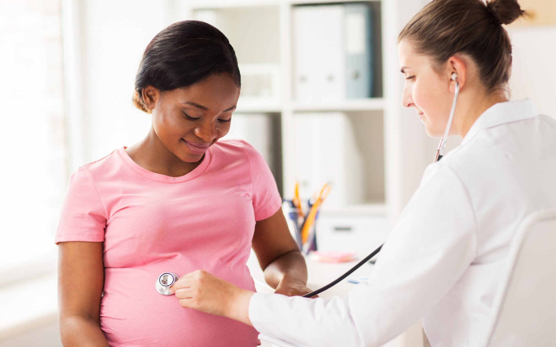 A doctor checking on a patient in her home in Burtonsville, Iowa.