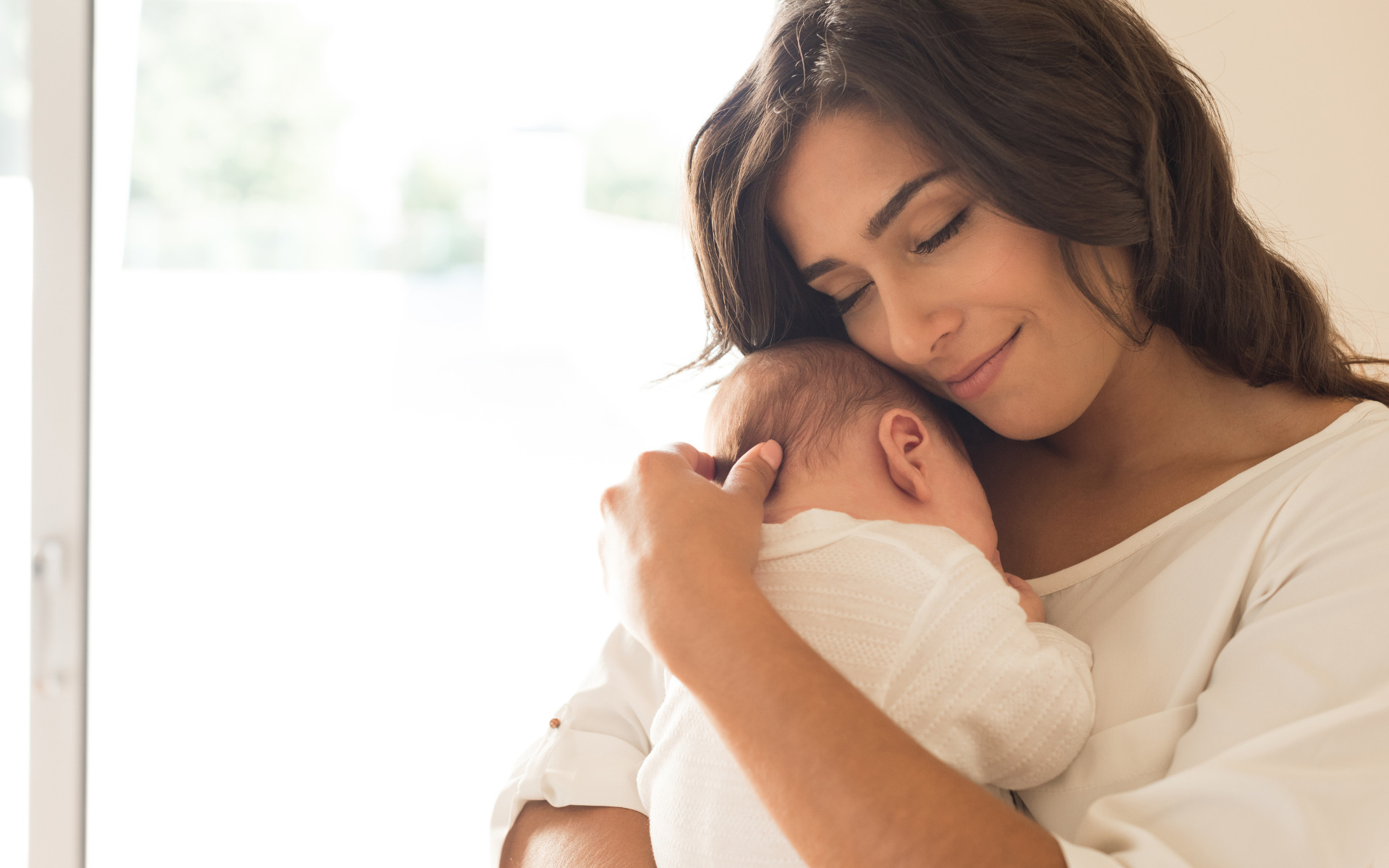 A mother holding her baby in their Burtonsville, MD home.