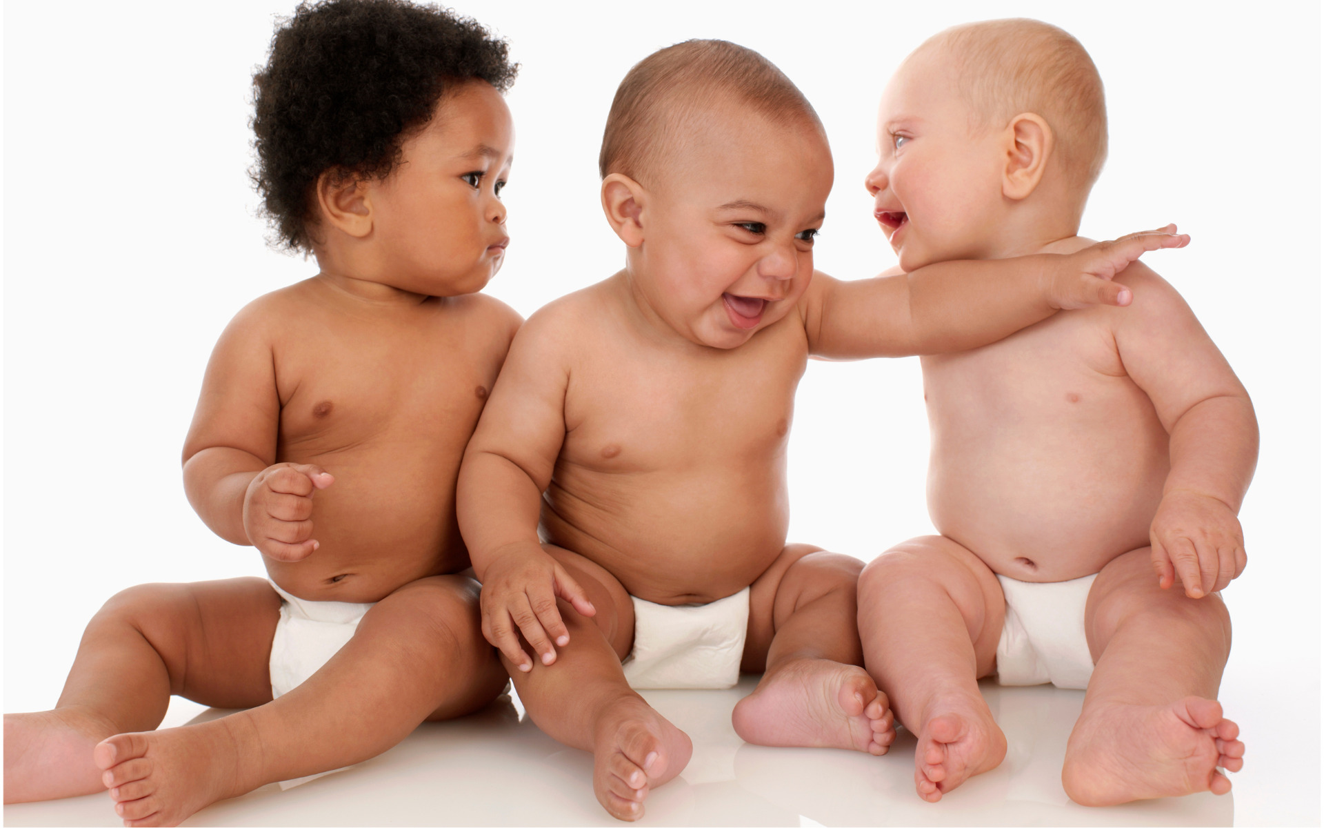 A trio of babies in diapers.