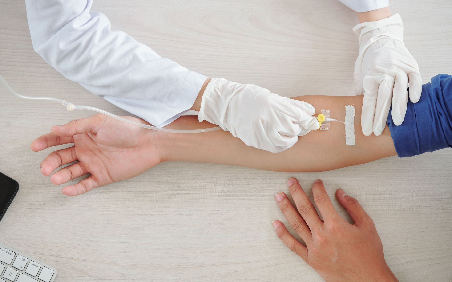 close up of nurse starting IV infusion to patient's arm