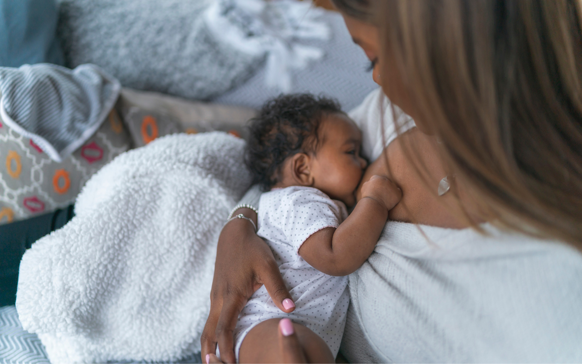 A mother breastfeeding her baby in their Burtonsville, MD home.