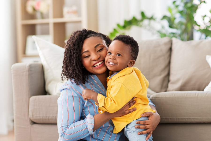 A mother holding her toddler son in their home in Burtonsville, MD.